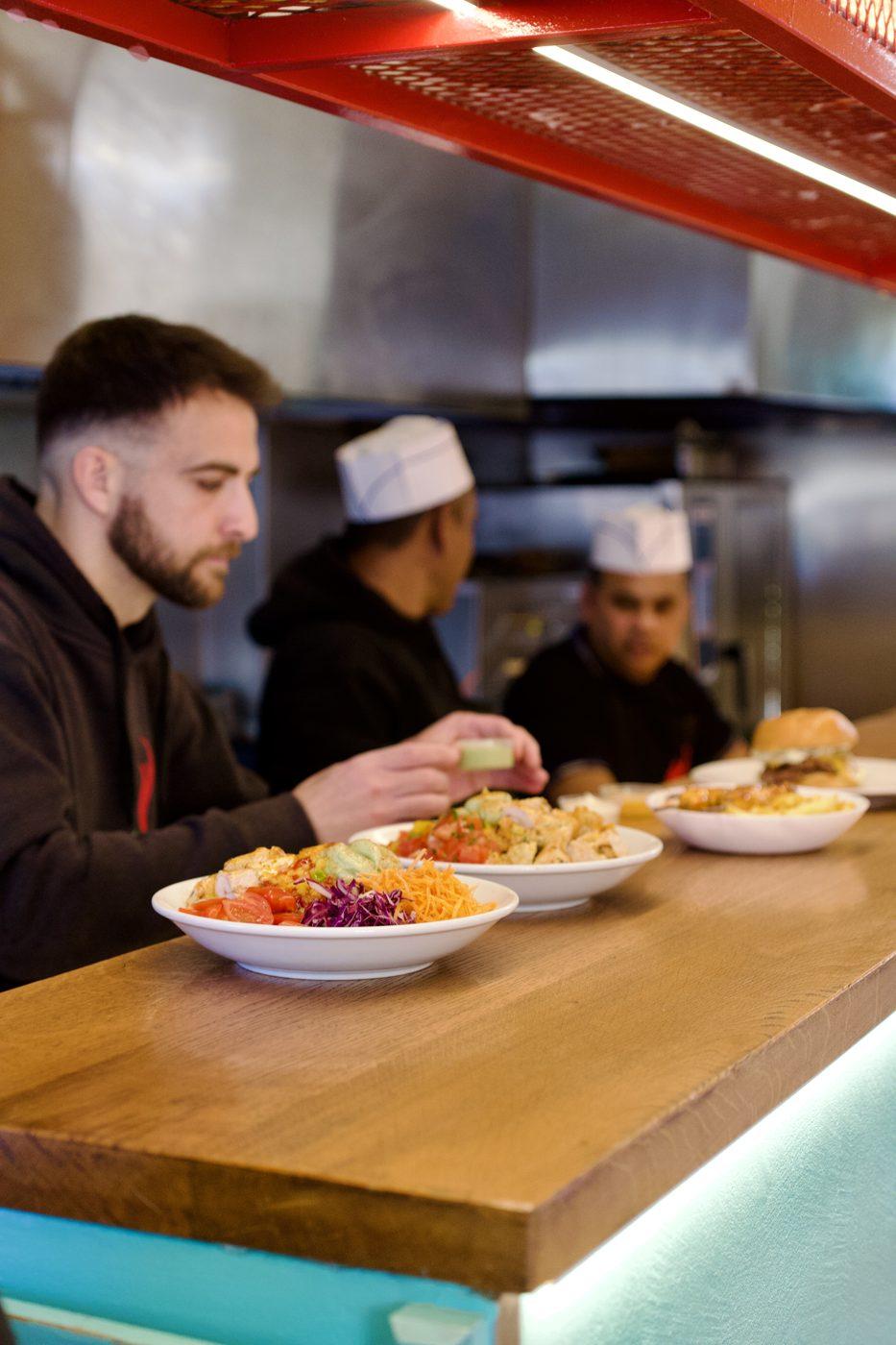 Team plating an order at the counter