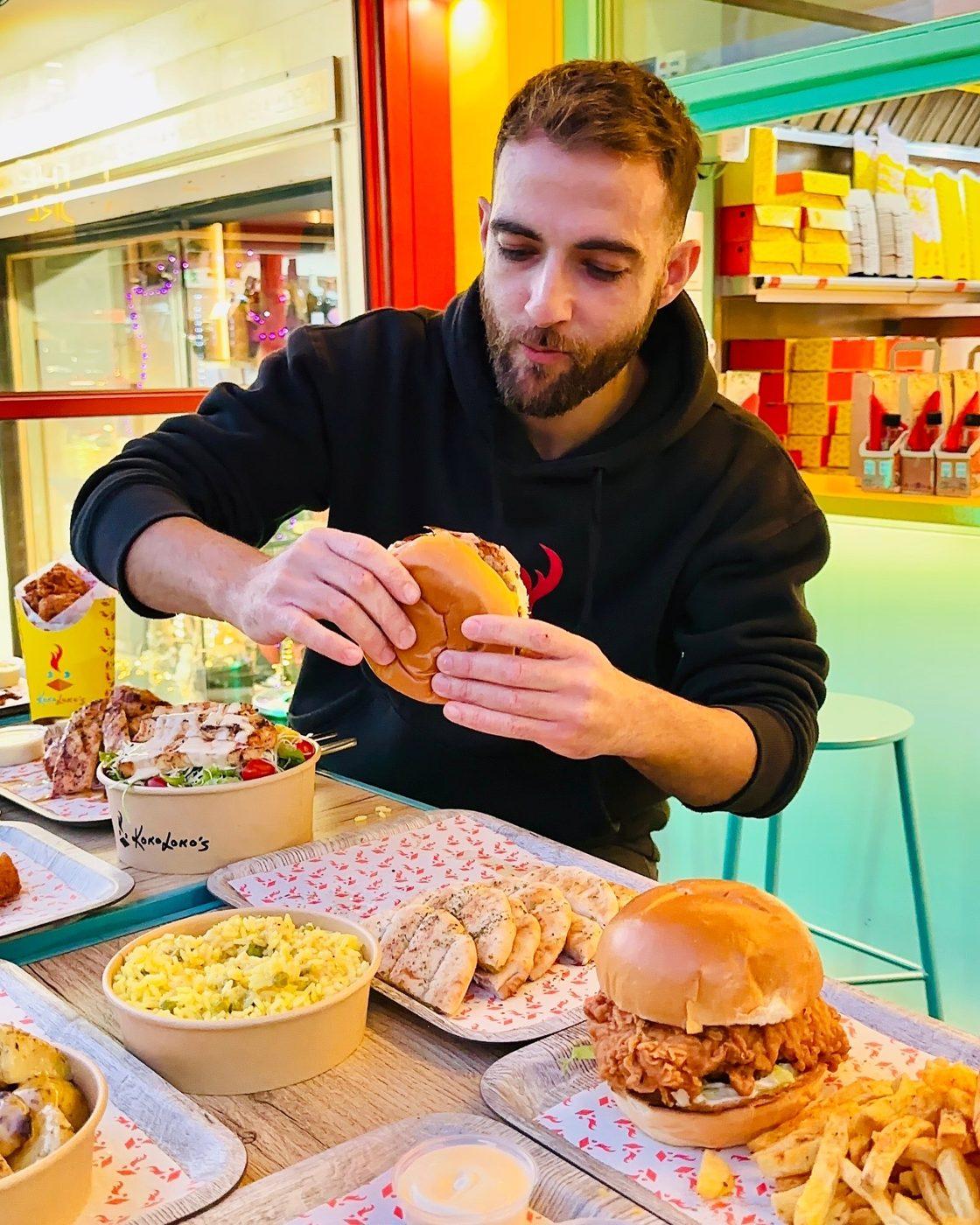 Customer enjoying a Kokolokos burger